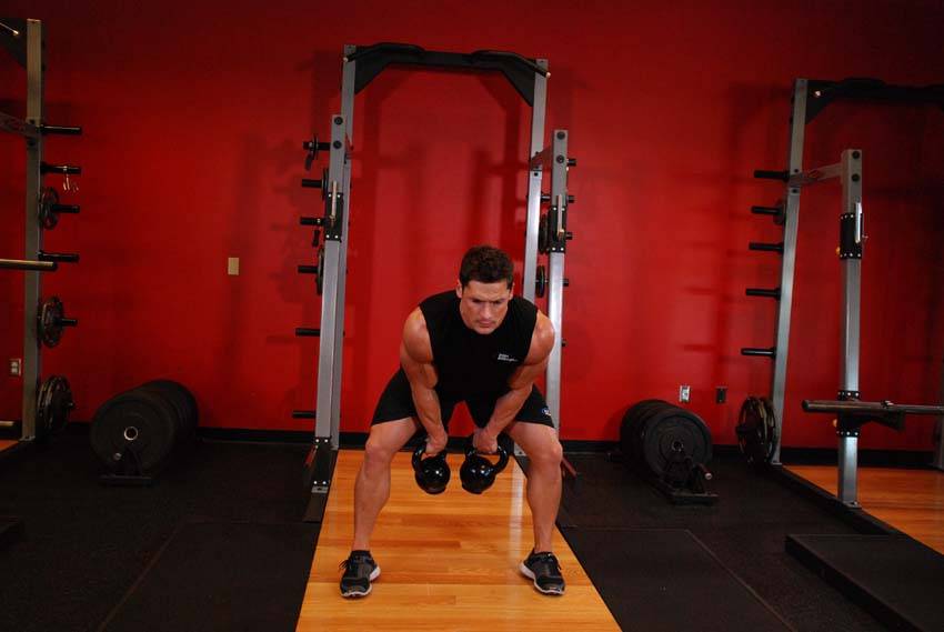 Double Kettlebell Snatch — end position, working the shoulders