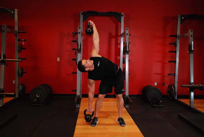 Double Kettlebell Windmill — end position, working the abs