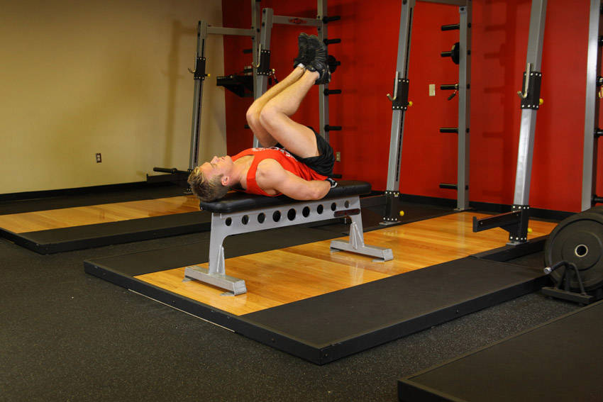 Flat Bench Leg Pull-In — starting position, working the abs