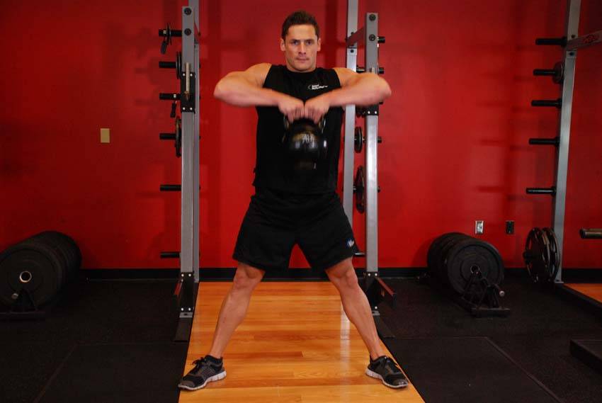 Kettlebell Sumo High Pull — end position, working the traps