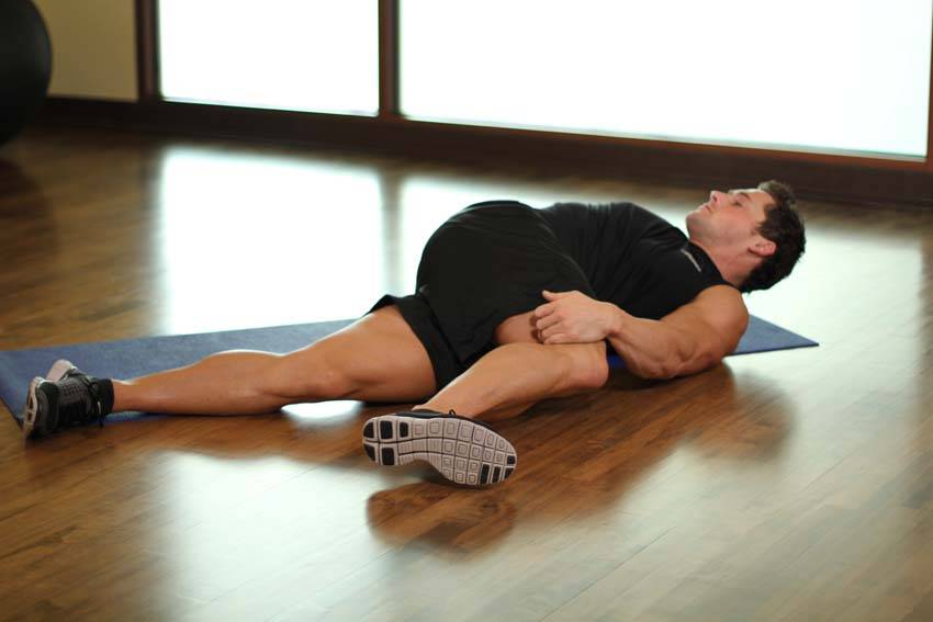 Knee Across The Body — end position, working the glutes