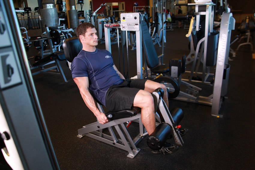 Leg Extensions — starting position, working the quads