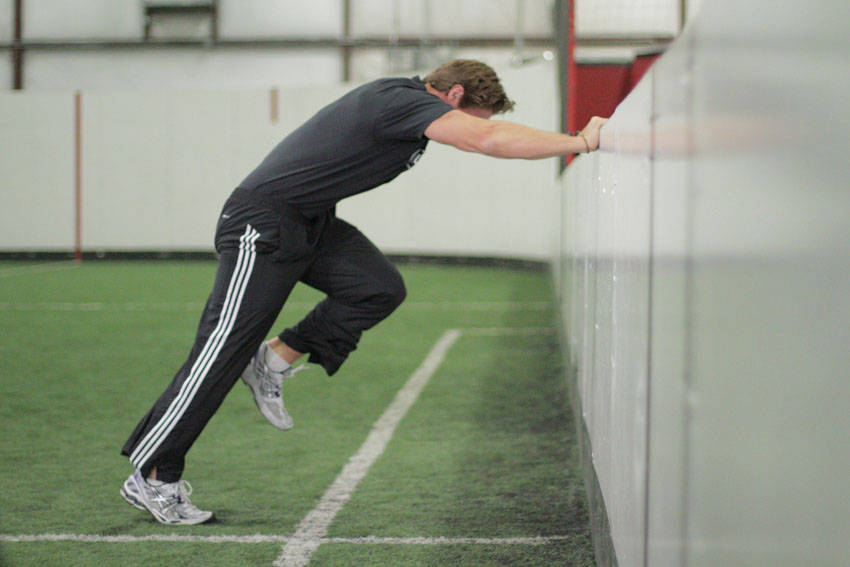 Linear Acceleration Wall Drill — starting position, working the hamstrings