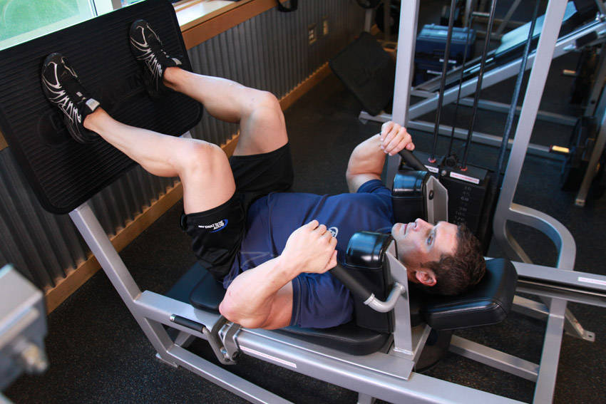 Lying Machine Squat — starting position, working the quads