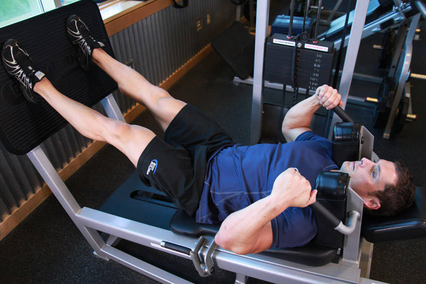 Lying Machine Squat — end position, working the quads