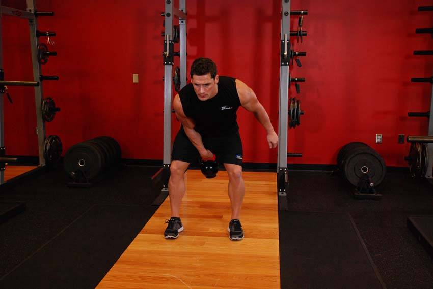 One-Arm Kettlebell Clean — end position, working the hamstrings