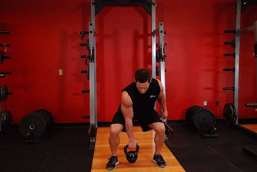 One-Arm Open Palm Kettlebell Clean — starting position, working the hamstrings
