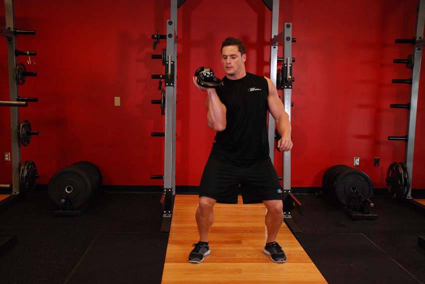 One-Arm Open Palm Kettlebell Clean — end position, working the hamstrings