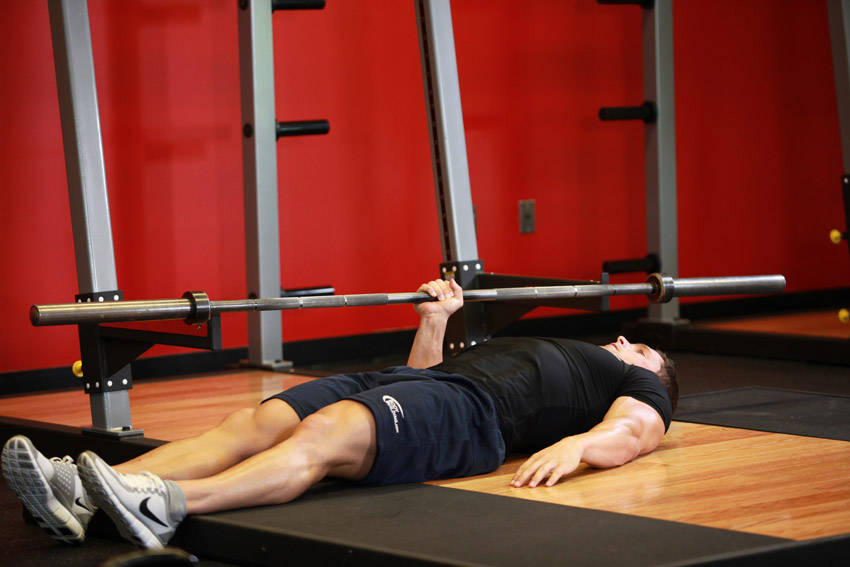 One Arm Floor Press — starting position, working the triceps