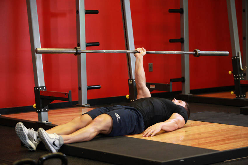One Arm Floor Press — end position, working the triceps