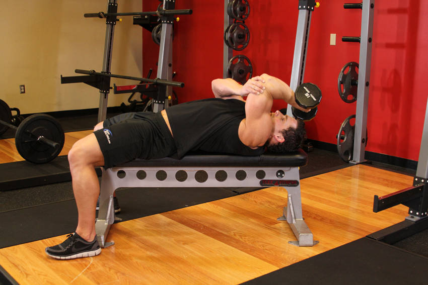 One Arm Pronated Dumbbell Triceps Extension — end position, working the triceps