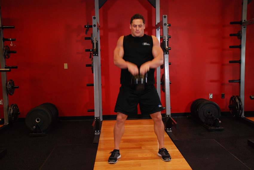 Open Palm Kettlebell Clean — end position, working the hamstrings