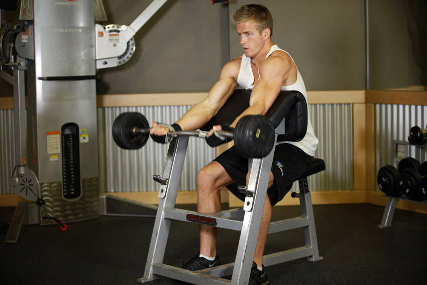 Preacher Curl — starting position, working the biceps