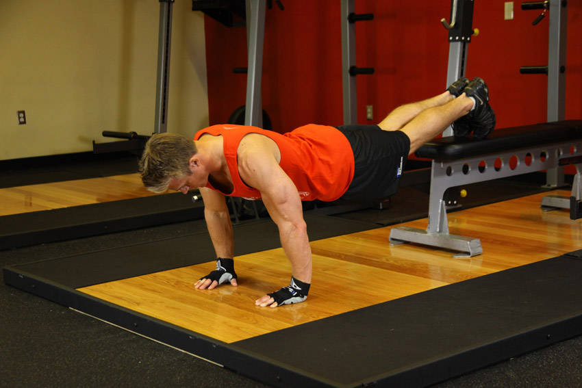 Push-Ups With Feet Elevated — starting position, working the chest