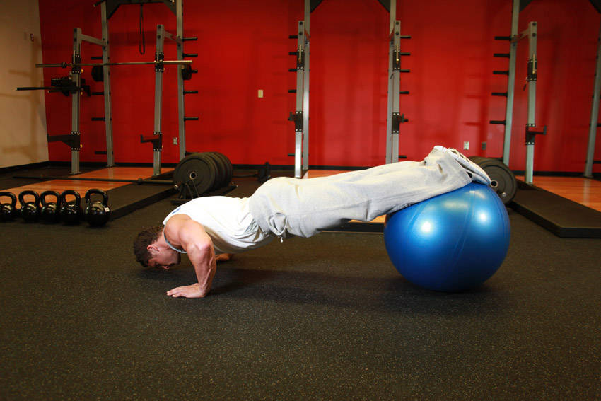 Push-Ups With Feet On An Exercise Ball — starting position, working the chest