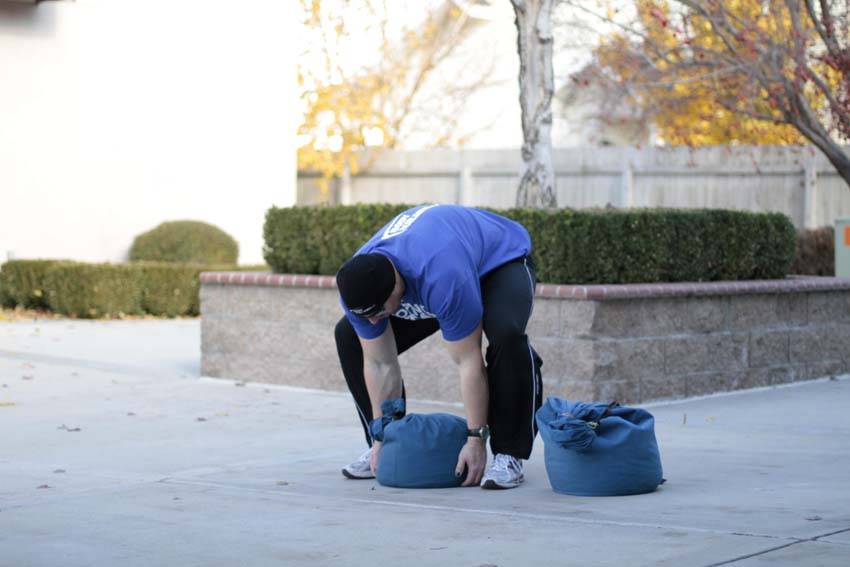 Sandbag Load — starting position, working the quads