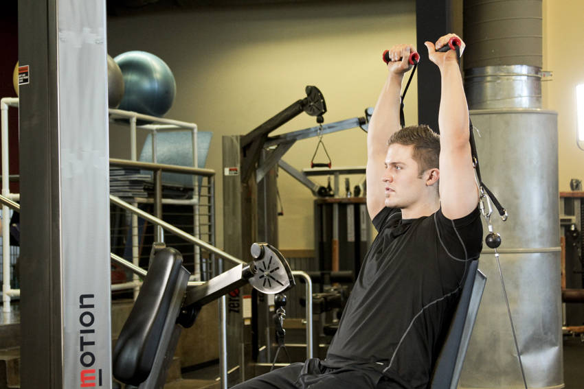 Seated Cable Shoulder Press — end position, working the shoulders