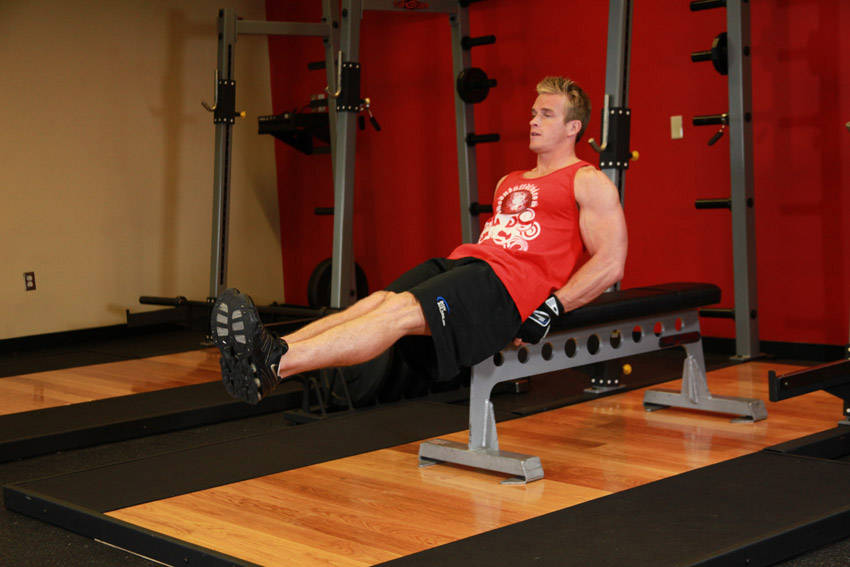 Seated Flat Bench Leg Pull-In — starting position, working the abs