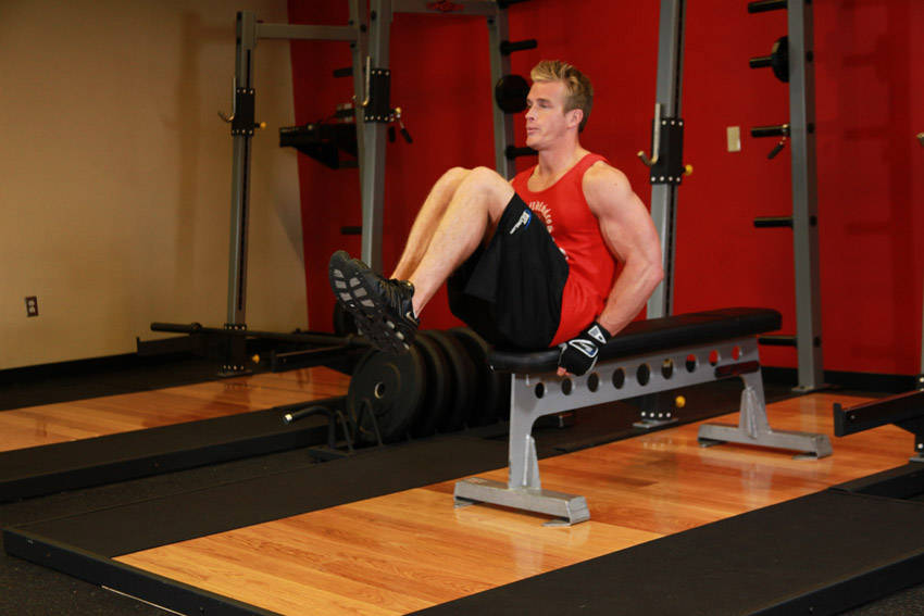 Seated Flat Bench Leg Pull-In — end position, working the abs