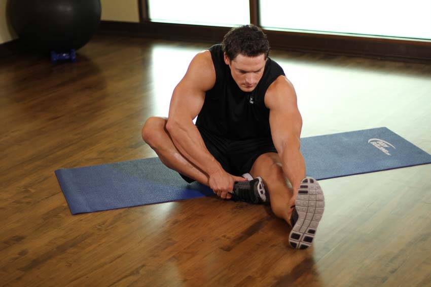 Seated Floor Hamstring Stretch — end position, working the hamstrings