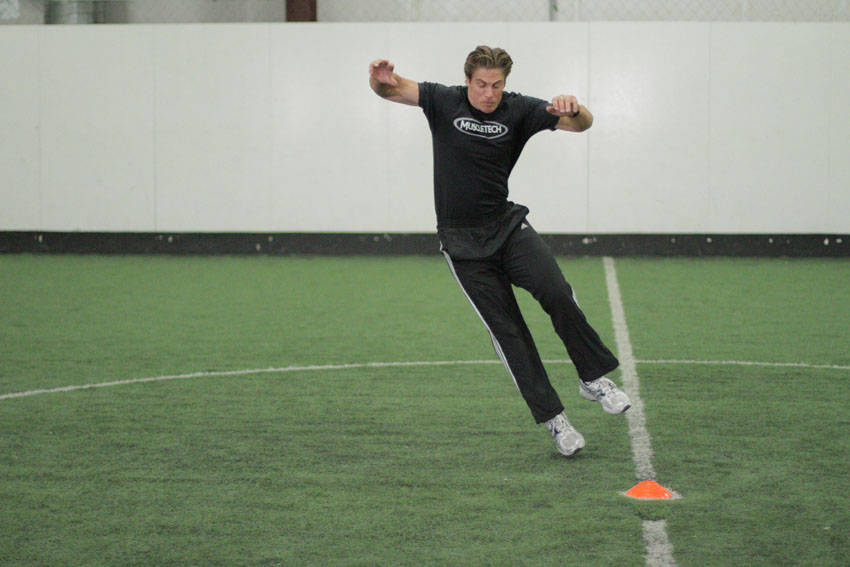 Side Standing Long Jump — end position, working the quads