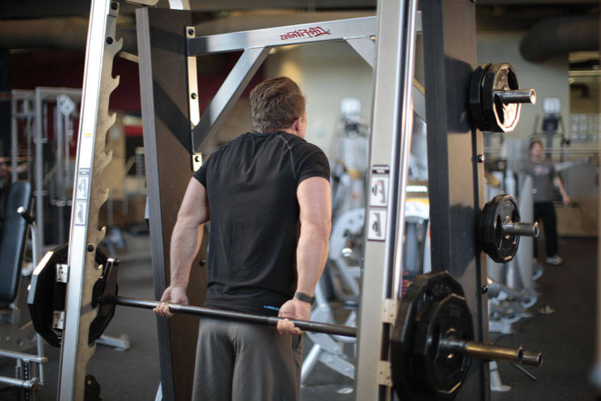 Smith Machine Behind the Back Shrug — end position, working the traps