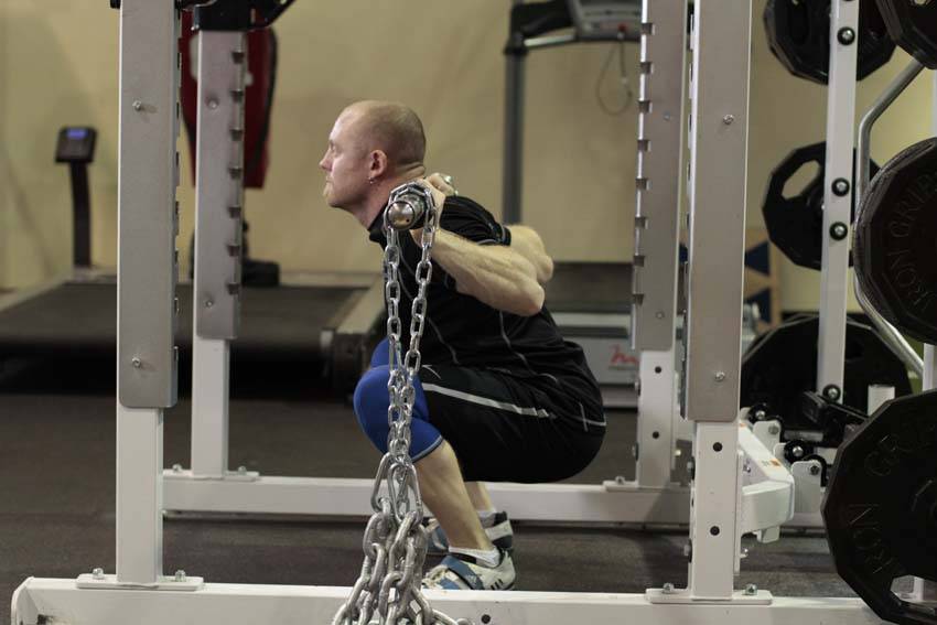 Squat with Chains — end position, working the quads