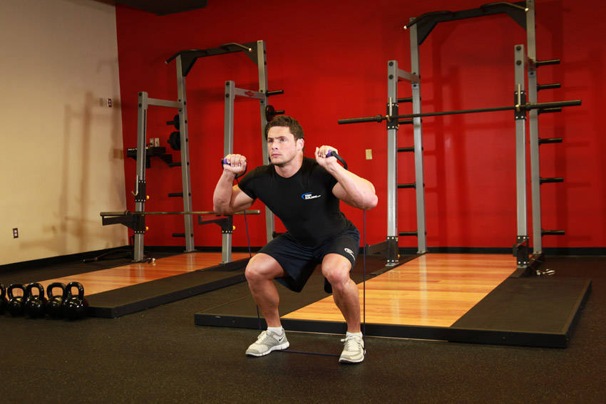 Squats - With Bands — end position, working the quads