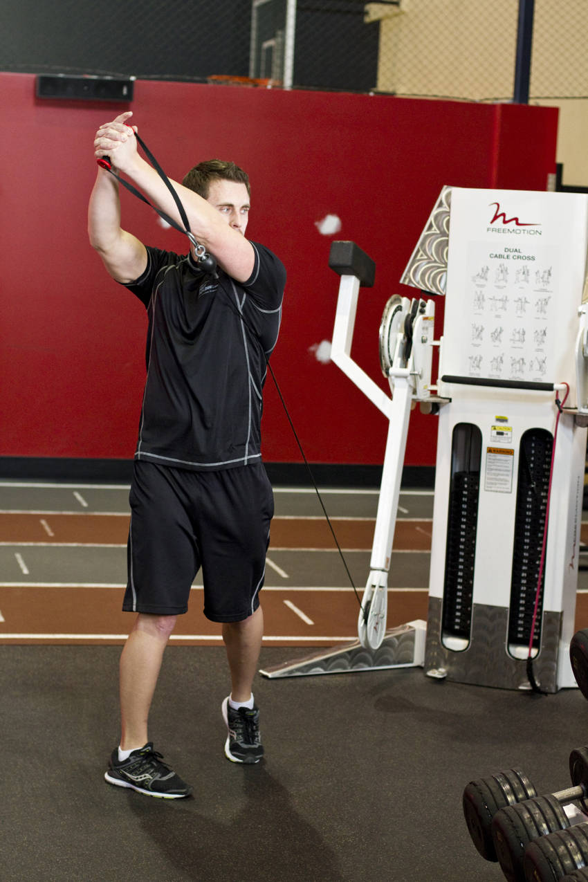 Standing Cable Lift — end position, working the abs