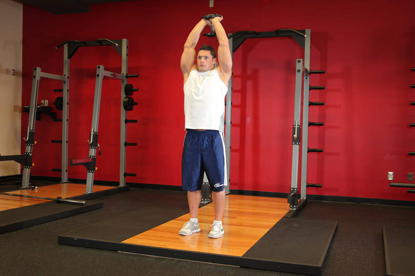 Standing Dumbbell Triceps Extension — starting position, working the triceps