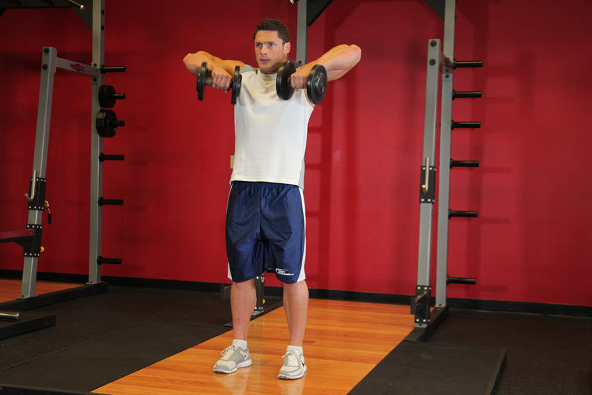 Standing Dumbbell Upright Row — starting position, working the traps
