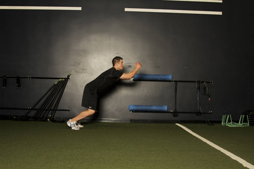 Standing Long Jump — end position, working the quads