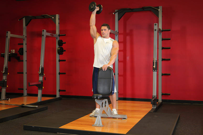 Standing Palm-In One-Arm Dumbbell Press — end position, working the shoulders