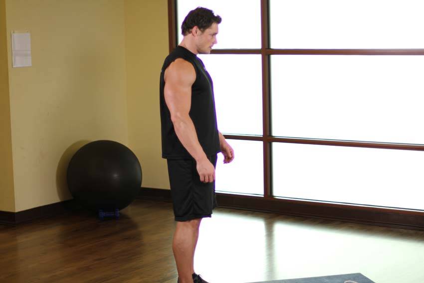 Standing Toe Touches — starting position, working the hamstrings