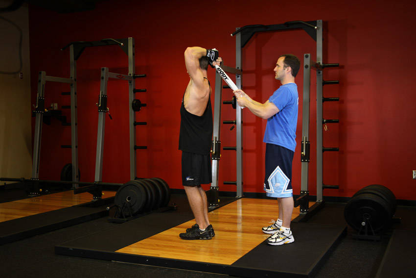 Standing Towel Triceps Extension — starting position, working the triceps