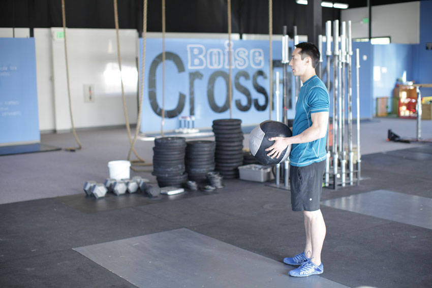 Standing Two-Arm Overhead Throw — starting position, working the shoulders