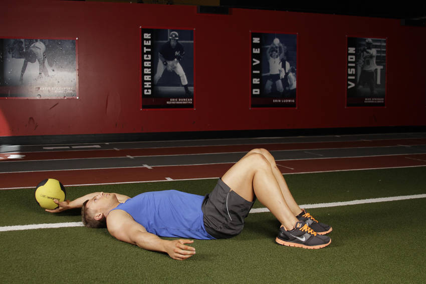 Supine One-Arm Overhead Throw — starting position, working the abs