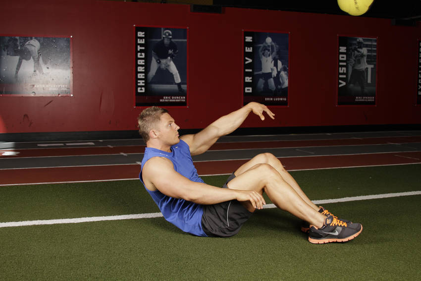 Supine One-Arm Overhead Throw — end position, working the abs