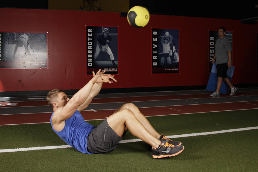 Supine Two-Arm Overhead Throw — end position, working the abs