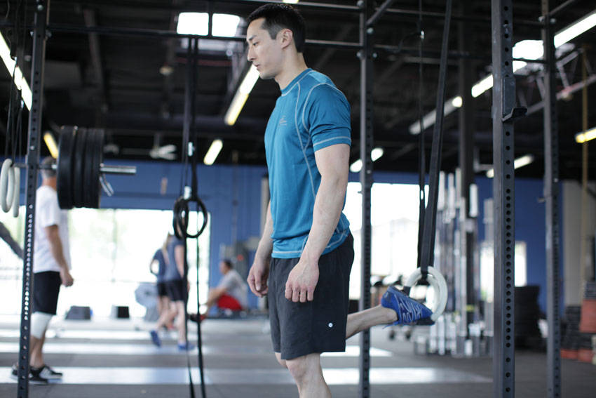 Suspended Split Squat — starting position, working the quads