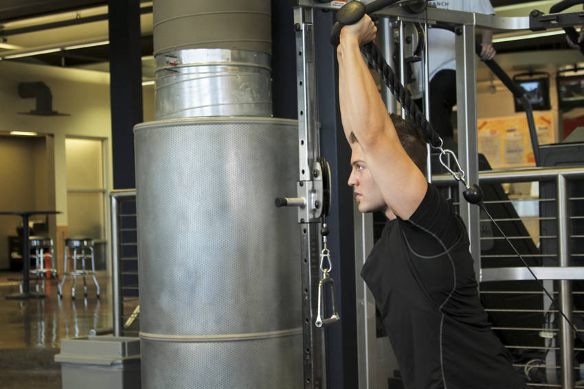 Triceps Overhead Extension with Rope — end position, working the triceps