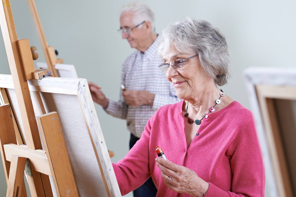 senior woman and man pursuing lifelong learning with a new hobby