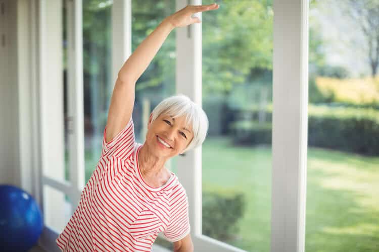 Senior woman performing a balance exercise.
