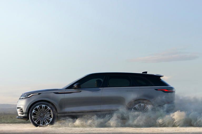 Range Rover driving on a dusty path