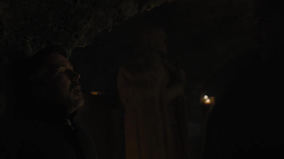 Littlefinger leans against the wall after being throttled by Jon.