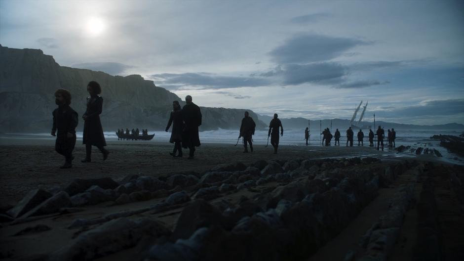 Tyrion and Missandei lead Jon and Davos off the beach while the Dothraki carry off their landing craft.