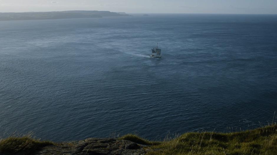 Jon's ship sits in the water off shore of the island.