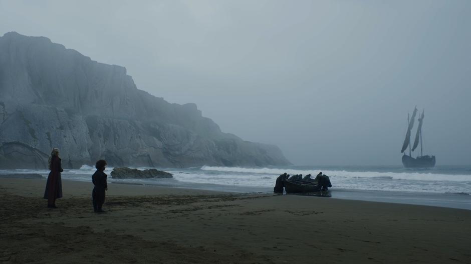 Dany and Tyrion watch Jon's party push their boat out into the bay while they ship waits anchored offshore.