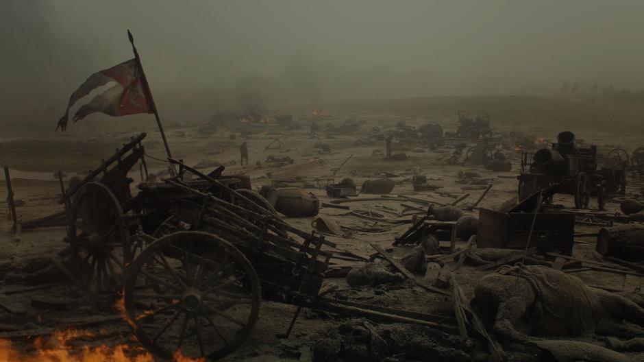 People walk through the scorched landscape in the aftermath of the battle.