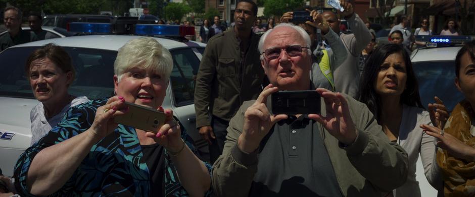 People look up and take photos of the blob.